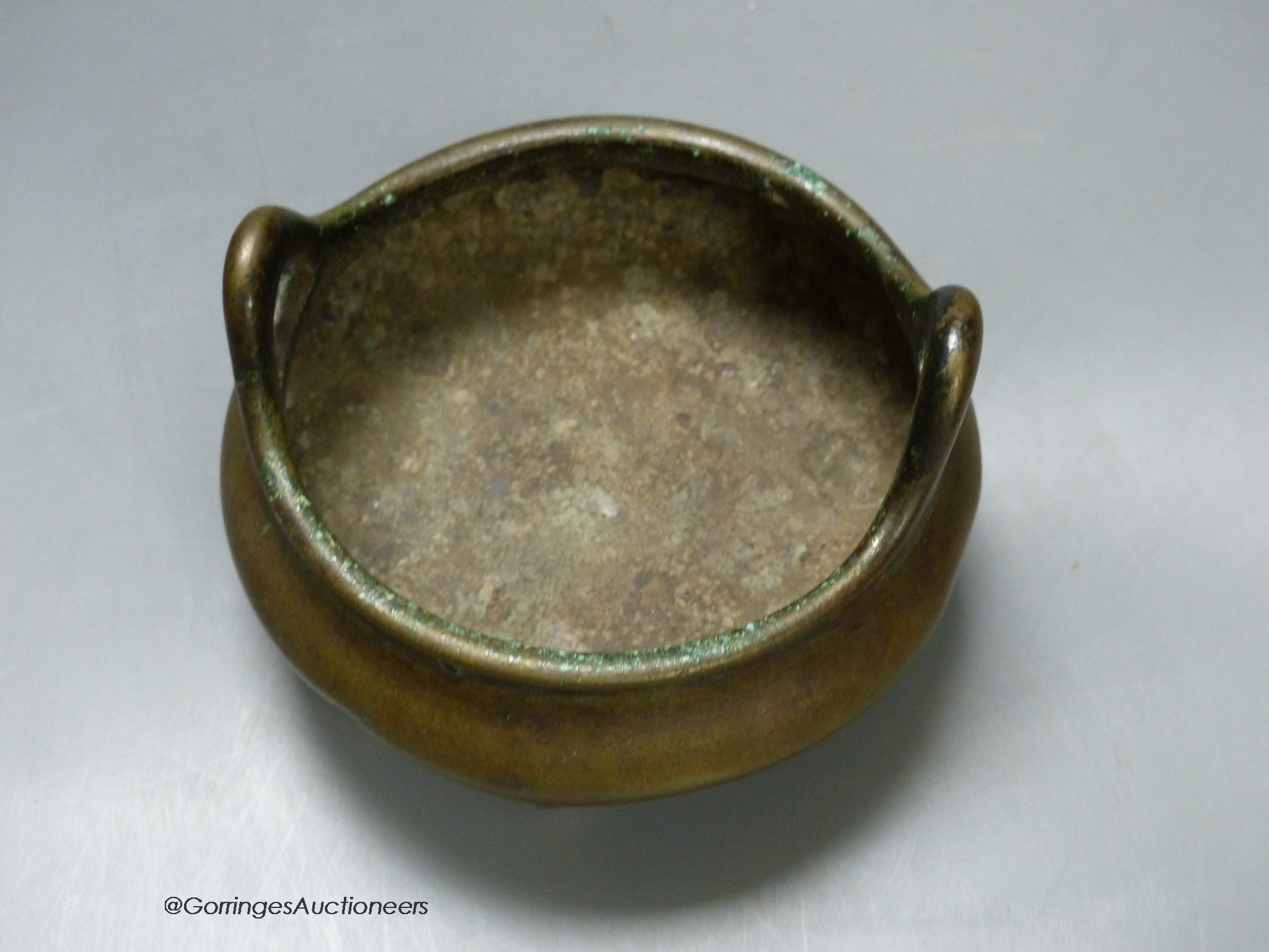 A 19th century Chinese circular bronze tripod censer, diameter 12cm